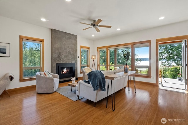 8996 Dearborn Ave, Blaine, WA 98230 - living room featuring recessed lighting, wood finished floors, a wealth of natural light, and a fireplace