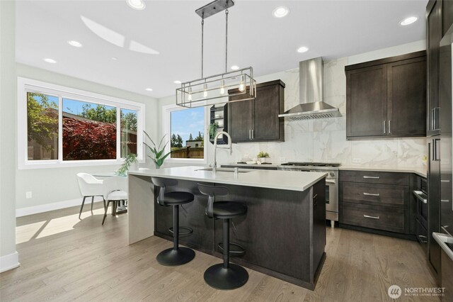 10284 133rd Ct NE, Redmond, WA 98033 - kitchen featuring wall chimney exhaust hood, a sink, gas stove, light countertops, and dark brown cabinetry