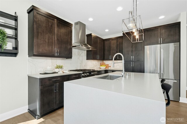 10284 133rd Ct NE, Redmond, WA 98033 - kitchen with wall chimney exhaust hood, appliances with stainless steel finishes, a sink, dark brown cabinets, and light countertops