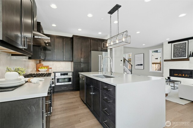 10284 133rd Ct NE, Redmond, WA 98033 - kitchen with stainless steel appliances, a sink, light wood-style flooring, light countertops, and recessed lighting