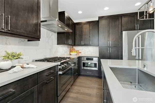 10284 133rd Ct NE, Redmond, WA 98033 - kitchen featuring appliances with stainless steel finishes, wall chimney range hood, a sink, dark brown cabinets, and light countertops