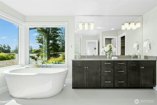 10284 133rd Ct NE, Redmond, WA 98033 - full bathroom featuring double vanity, a soaking tub, plenty of natural light, and tile patterned floors