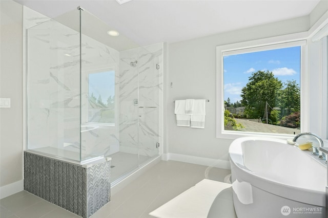 10284 133rd Ct NE, Redmond, WA 98033 - bathroom with baseboards, a marble finish shower, tile patterned floors, a freestanding tub, and recessed lighting