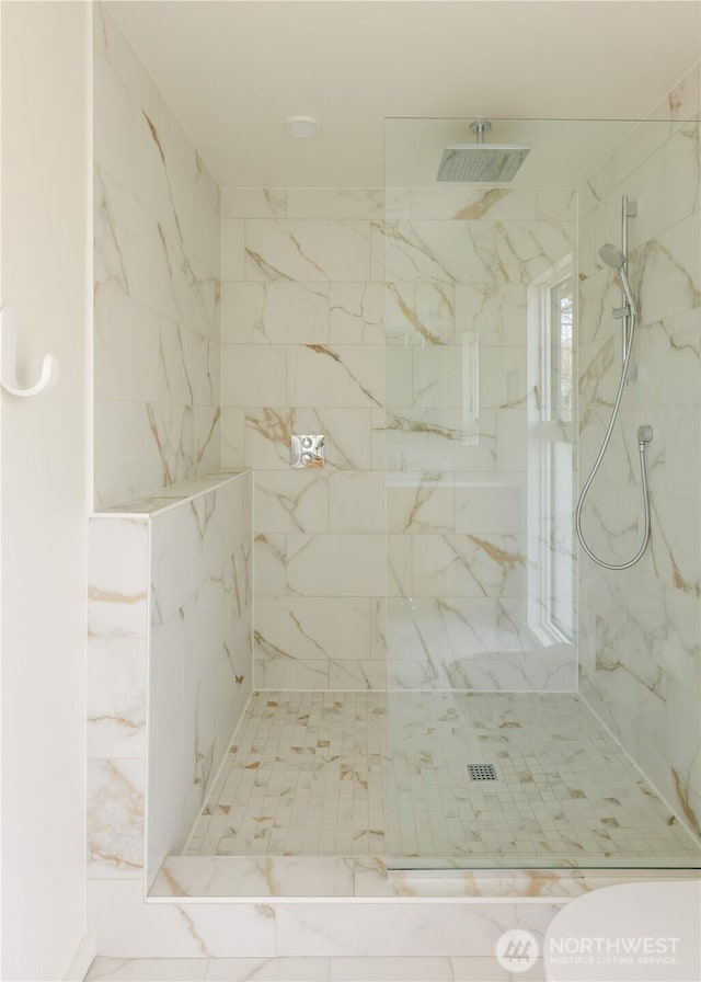 full bath with a marble finish shower
