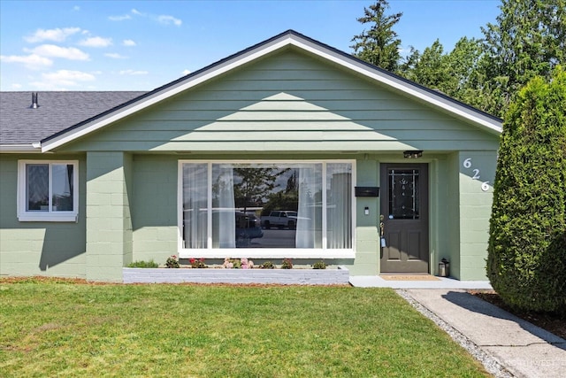 626 Legion Dr, Everett, WA 98201 - view of front of house with roof with shingles, a front lawn, and concrete block siding