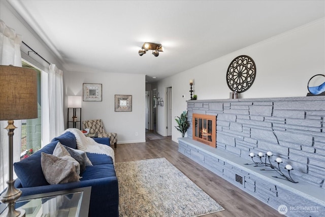 626 Legion Dr, Everett, WA 98201 - living area with wood finished floors, baseboards, and a stone fireplace
