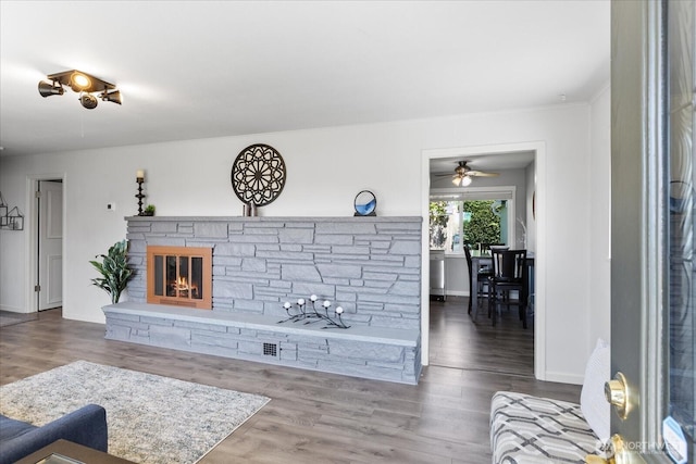 626 Legion Dr, Everett, WA 98201 - living area featuring ceiling fan, wood finished floors, a fireplace, and baseboards
