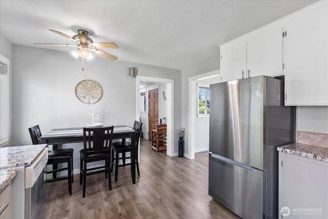 626 Legion Dr, Everett, WA 98201 - dining area featuring a ceiling fan, wood finished floors, and baseboards