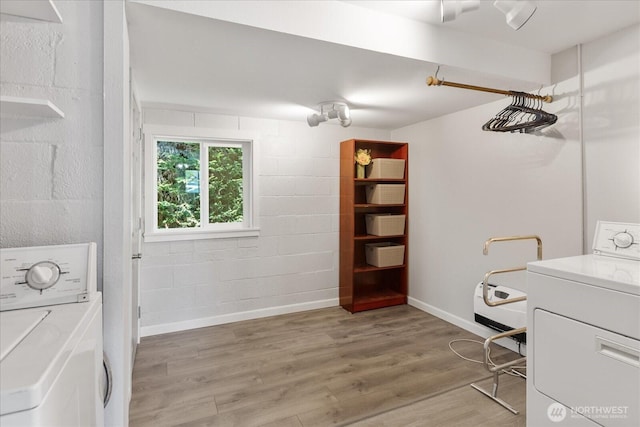 626 Legion Dr, Everett, WA 98201 - laundry room featuring washer / dryer, light wood-type flooring, baseboards, and concrete block wall