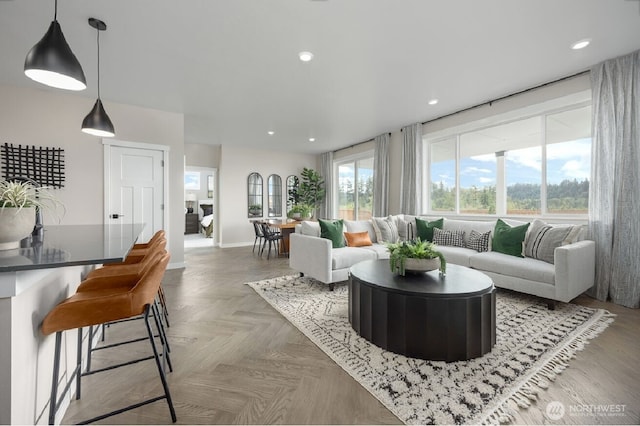 living area featuring baseboards and recessed lighting