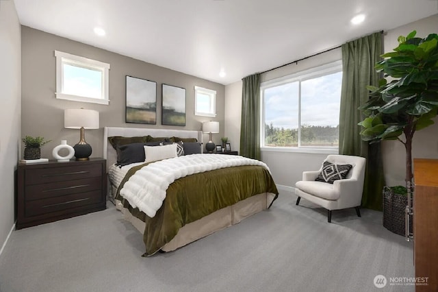 carpeted bedroom with recessed lighting, baseboards, and multiple windows