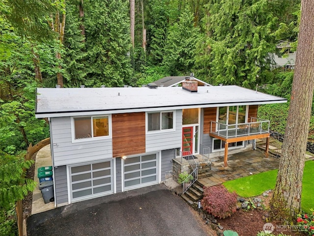320 SW Forest Dr, Issaquah, WA 98027 - raised ranch with asphalt driveway, a garage, and a balcony