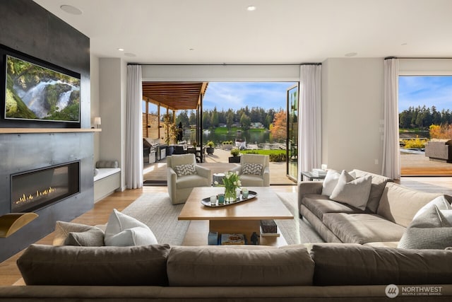 living room featuring light wood-style floors and a fireplace
