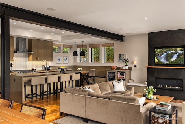 living area featuring a fireplace, recessed lighting, and wood finished floors