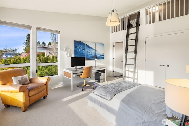 carpeted bedroom with baseboards and a high ceiling