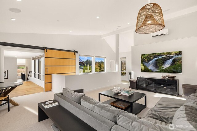 living room featuring high vaulted ceiling, a wall mounted air conditioner, a barn door, light colored carpet, and recessed lighting