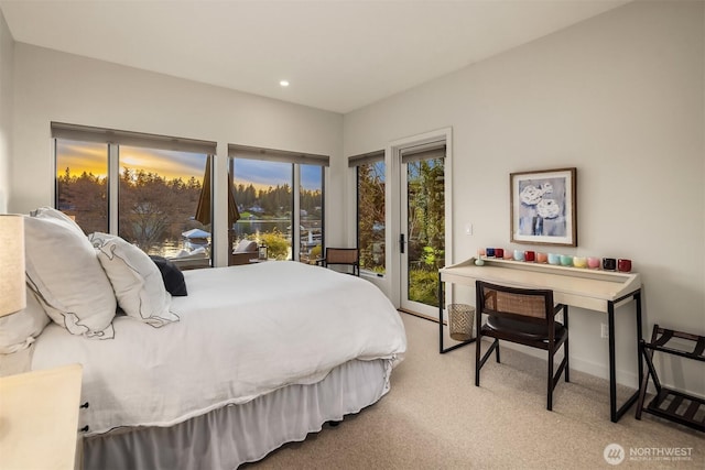 bedroom featuring recessed lighting, carpet, and access to exterior