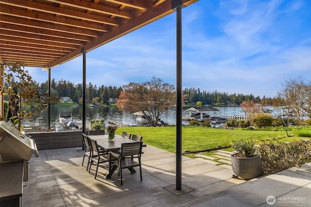 view of patio featuring outdoor dining area and a water view