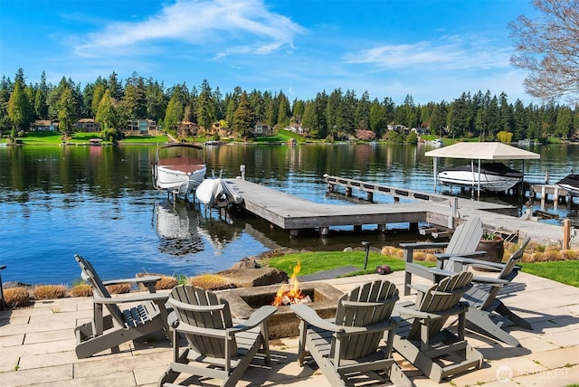 dock area with a water view and a fire pit