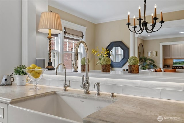 details with a sink, a chandelier, light countertops, decorative light fixtures, and ornamental molding
