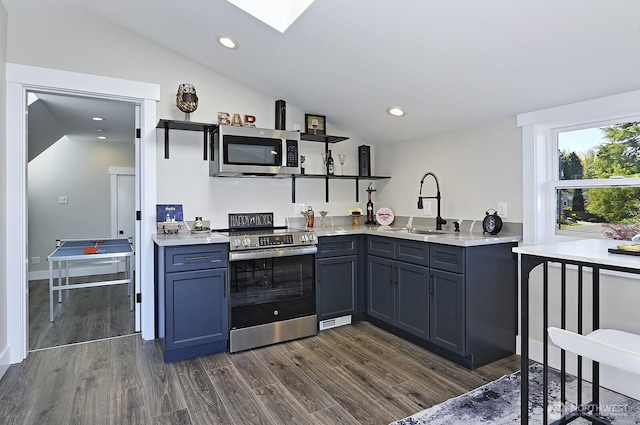 8536 S 114th St, Seattle, WA 98178 - kitchen with vaulted ceiling with skylight, open shelves, dark wood-type flooring, appliances with stainless steel finishes, and a sink