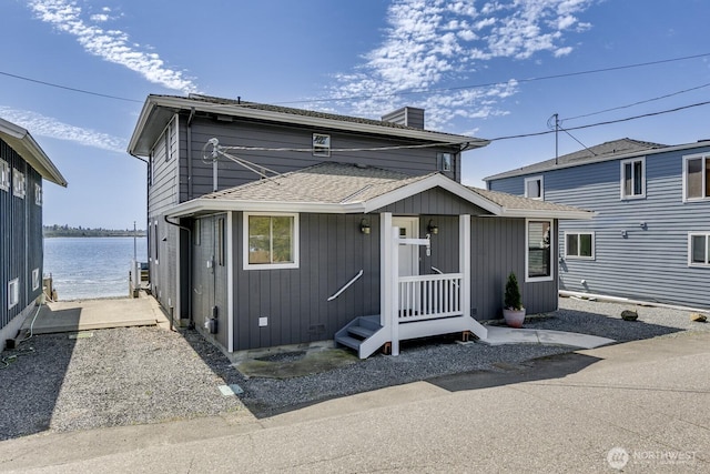 200 Priest Point Dr NE, Tulalip, WA 98271 - traditional-style house with a water view, roof with shingles, and a chimney