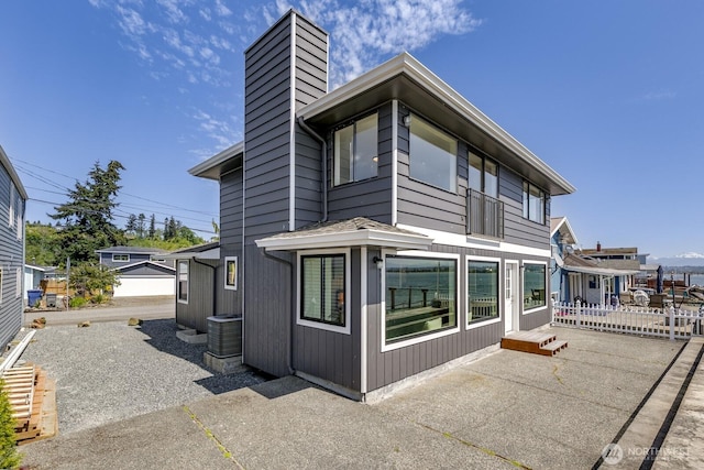 200 Priest Point Dr NE, Tulalip, WA 98271 - back of house featuring fence, a patio area, and a chimney