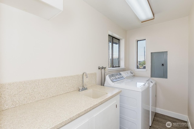 200 Priest Point Dr NE, Tulalip, WA 98271 - washroom featuring wood finished floors, a sink, laundry area, electric panel, and independent washer and dryer