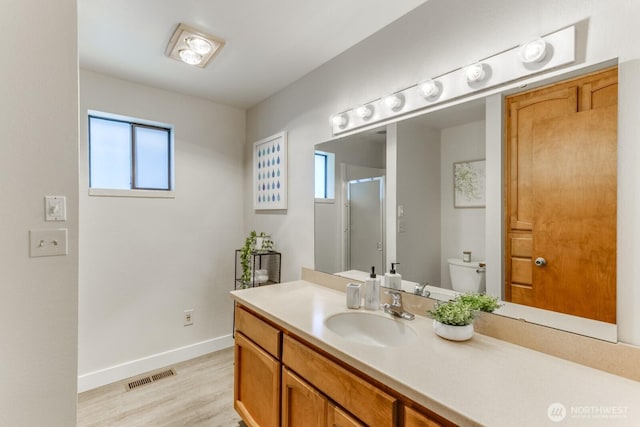 200 Priest Point Dr NE, Tulalip, WA 98271 - bathroom featuring a healthy amount of sunlight, baseboards, visible vents, and wood finished floors
