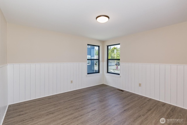 200 Priest Point Dr NE, Tulalip, WA 98271 - spare room with wainscoting, visible vents, and wood finished floors