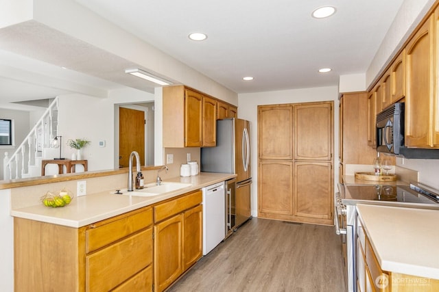 200 Priest Point Dr NE, Tulalip, WA 98271 - kitchen with a sink, dishwasher, electric stove, black microwave, and light wood-style floors