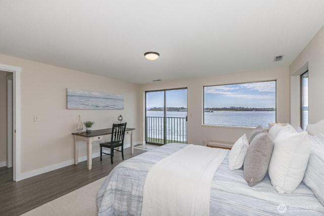 200 Priest Point Dr NE, Tulalip, WA 98271 - bedroom with baseboards, visible vents, a water view, access to outside, and wood finished floors