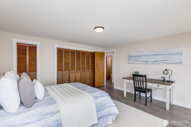 200 Priest Point Dr NE, Tulalip, WA 98271 - bedroom featuring baseboards, multiple closets, and wood finished floors