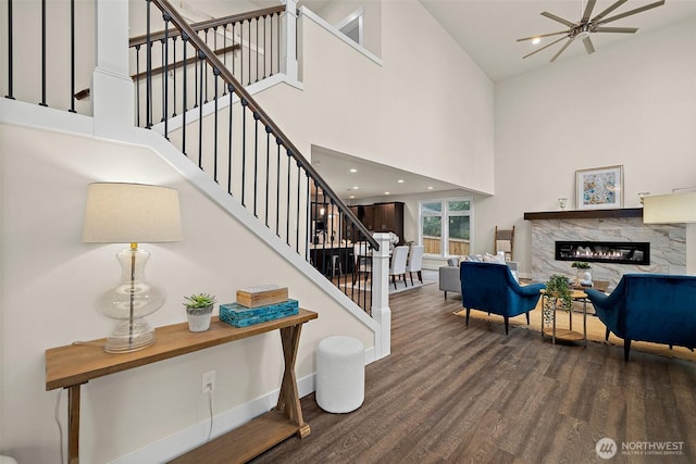 3711 S 349th Pl, Auburn, WA 98001 - interior space featuring baseboards, a high end fireplace, stairway, a towering ceiling, and wood finished floors