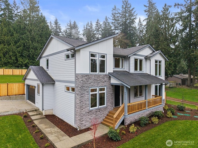 3711 S 349th Pl, Auburn, WA 98001 - contemporary home featuring stone siding, board and batten siding, an attached garage, a porch, and fence
