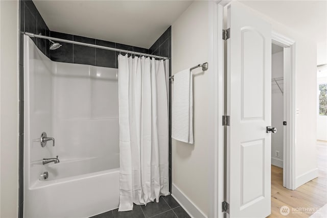 full bathroom featuring baseboards and shower / bath combination with curtain