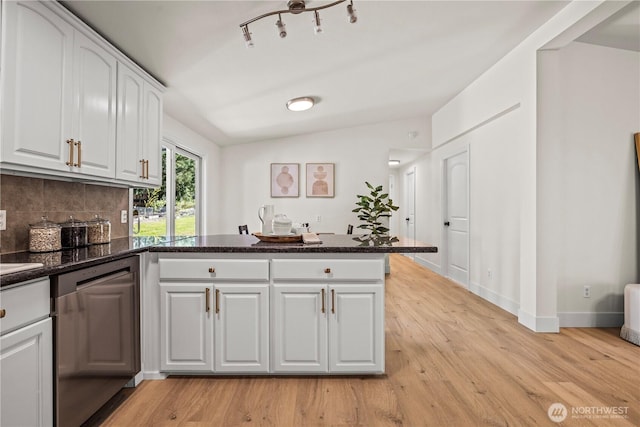 kitchen with white cabinets, a peninsula, light wood-style flooring, and dishwasher