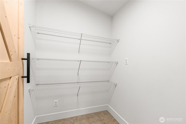 walk in closet featuring light tile patterned floors