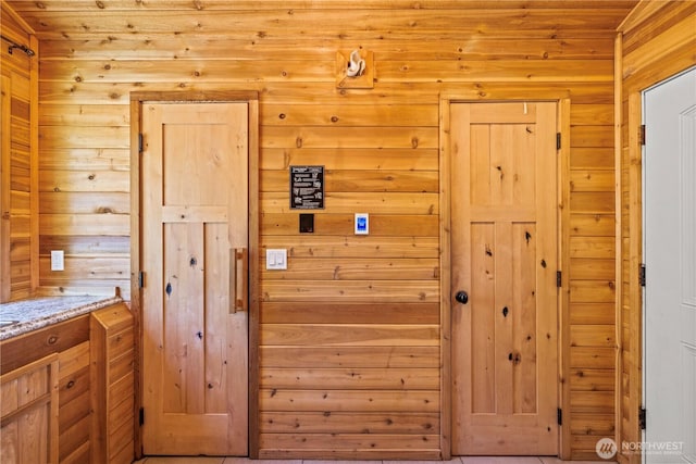 interior space featuring wooden walls and wood ceiling