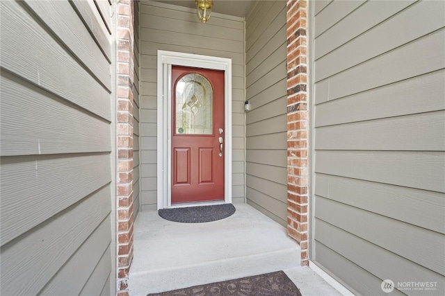 view of exterior entry with brick siding