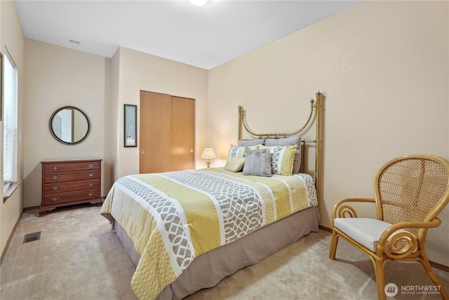 carpeted bedroom with baseboards, visible vents, and multiple windows