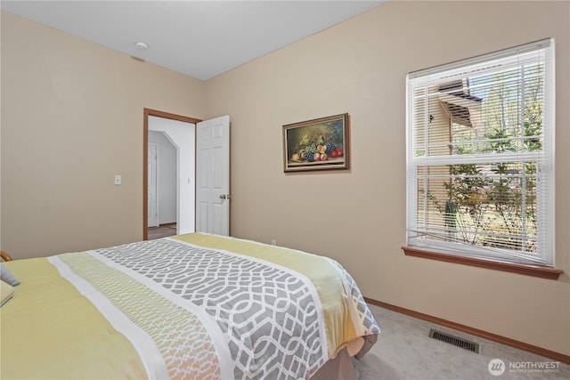 bedroom with carpet, visible vents, and baseboards