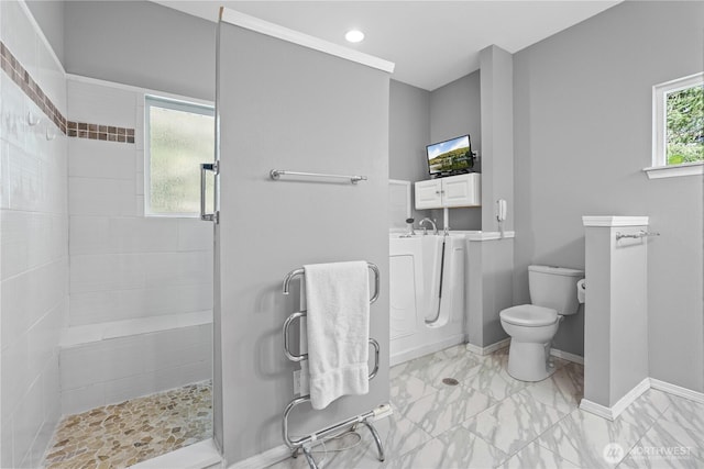 full bathroom with recessed lighting, marble finish floor, toilet, baseboards, and tiled shower