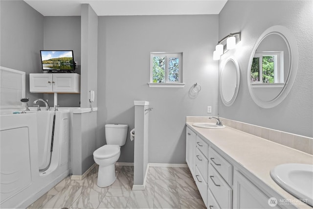 full bath featuring plenty of natural light, a sink, and toilet