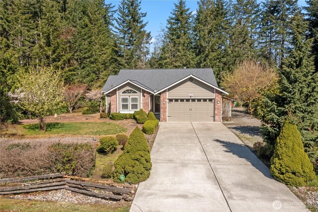 ranch-style house featuring an attached garage, driveway, and brick siding