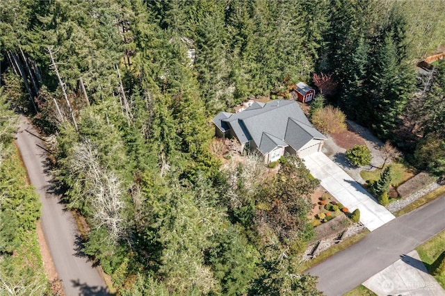 birds eye view of property with a wooded view