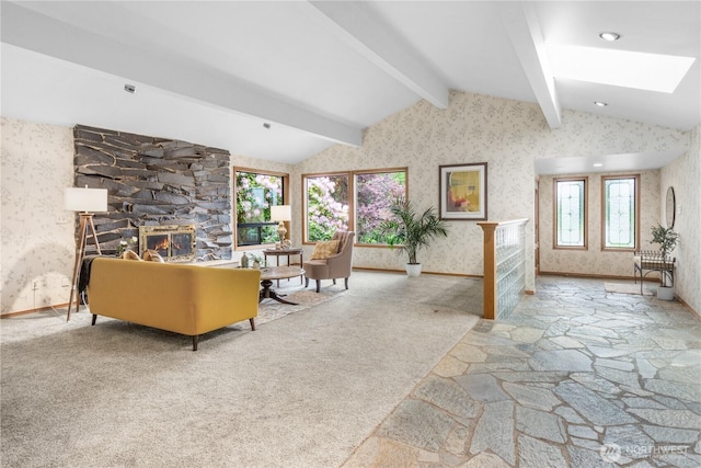 806 Alpine Dr, Everett, WA 98203 - living room with wallpapered walls, stone flooring, a fireplace, baseboards, and a skylight
