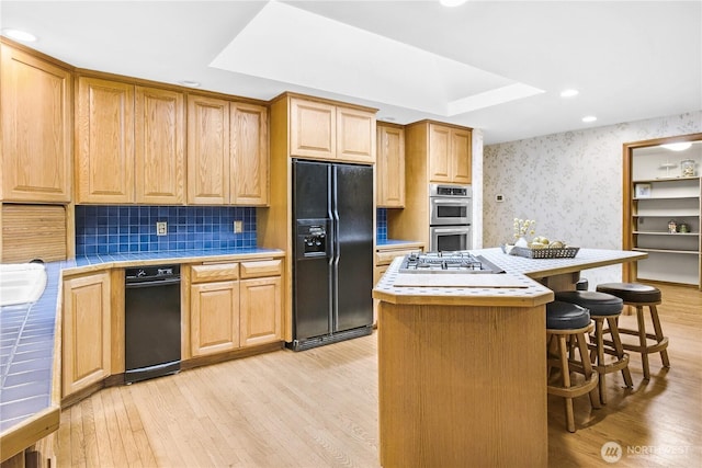 806 Alpine Dr, Everett, WA 98203 - kitchen featuring appliances with stainless steel finishes, tile countertops, wallpapered walls, light wood finished floors, and a breakfast bar