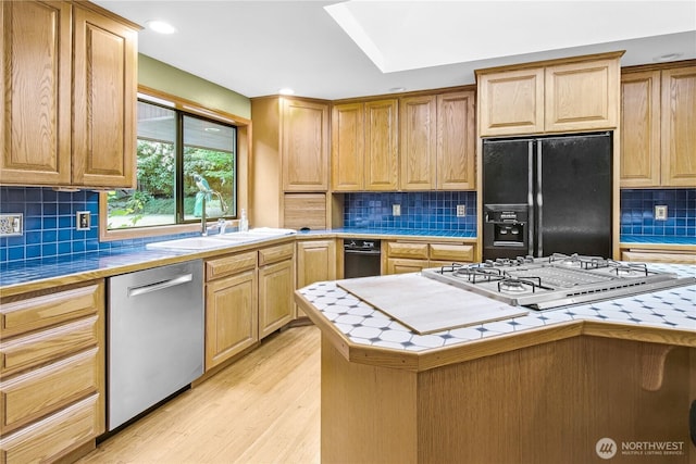 806 Alpine Dr, Everett, WA 98203 - kitchen with appliances with stainless steel finishes, tile counters, decorative backsplash, light wood-style flooring, and recessed lighting