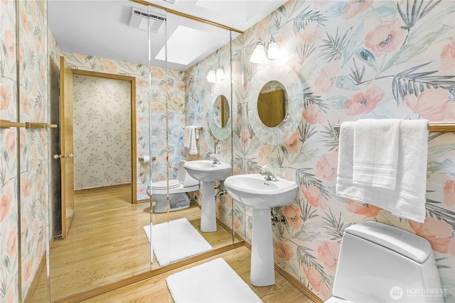 806 Alpine Dr, Everett, WA 98203 - bathroom with toilet, wallpapered walls, wood finished floors, a skylight, and baseboards